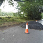 asphalt road lay next to traffic cones